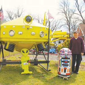 Aero Acres resident Ron Alder stands next to his homemade UFO, 2016